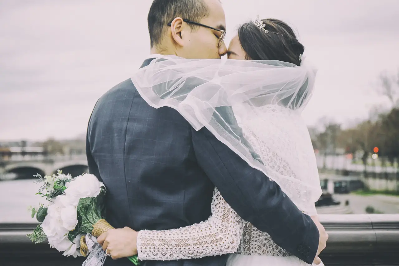 Couple walking through a field of flowers during an engagement photoshoot.